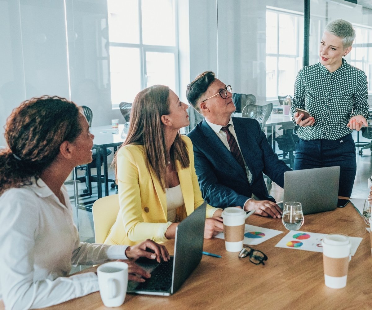 Business team collaborating around a laptop